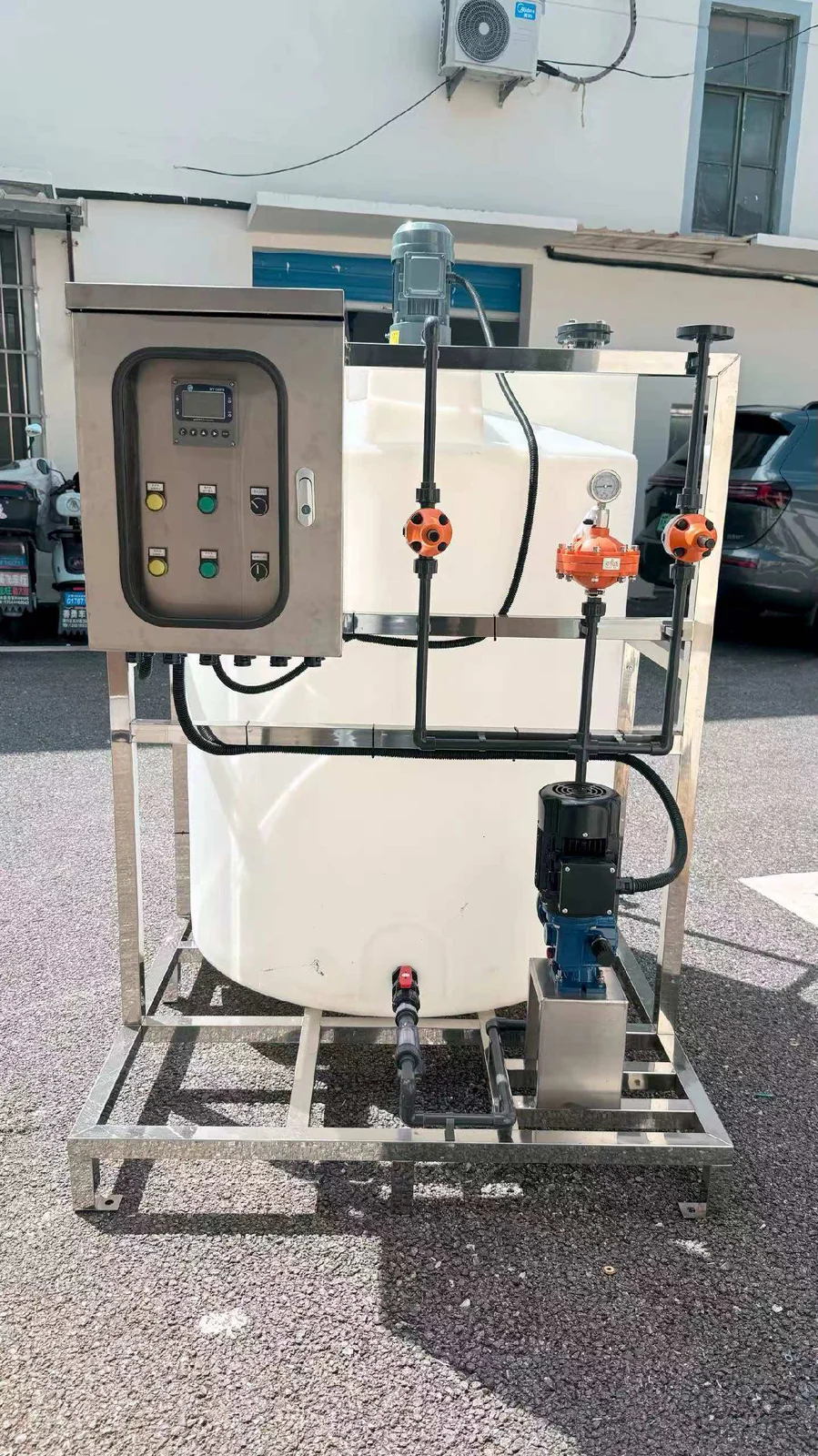 Dosing skid with tanks, pumps, pipework and a control enclosure