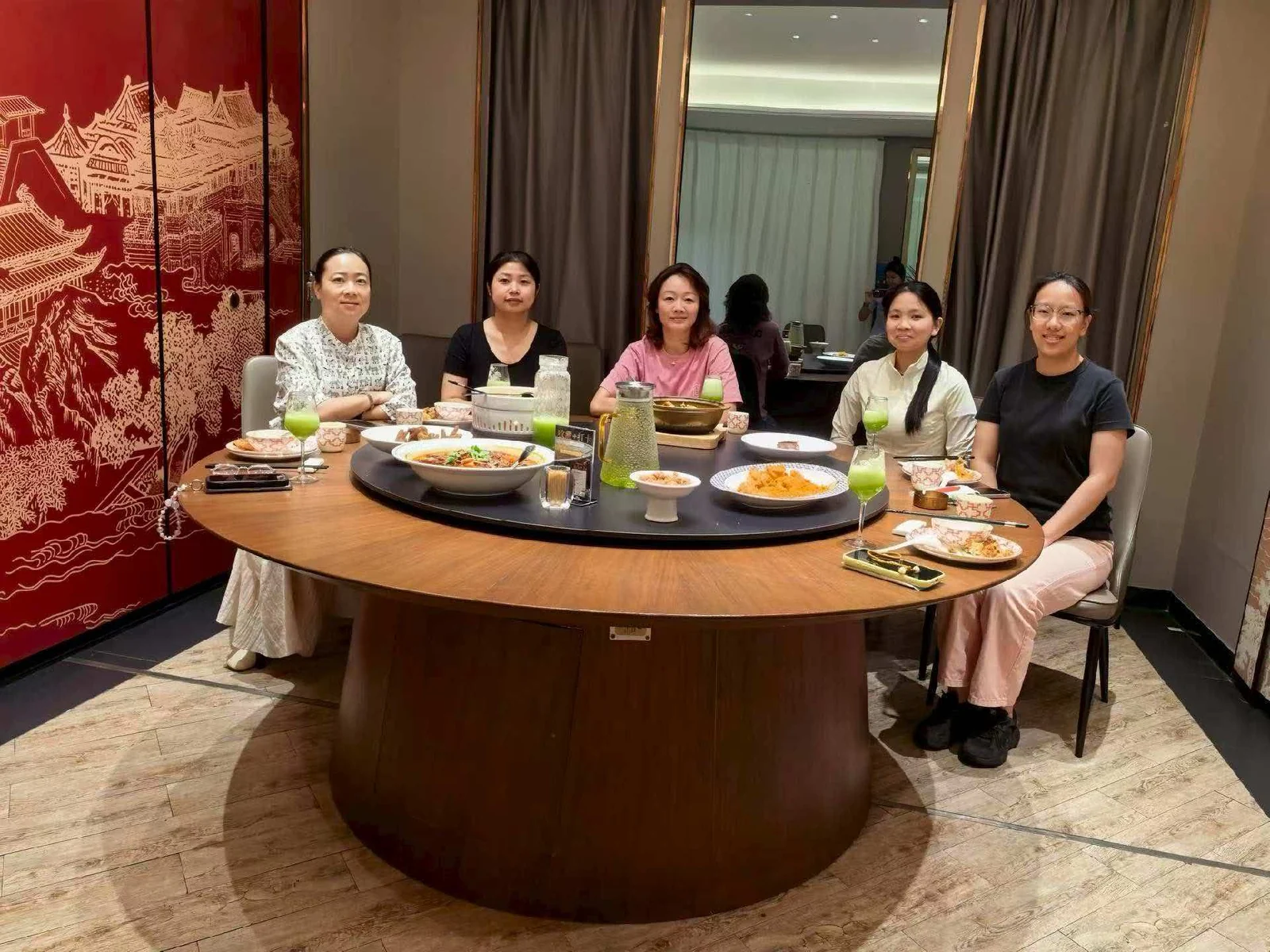 Team members seated around a table at a gathering